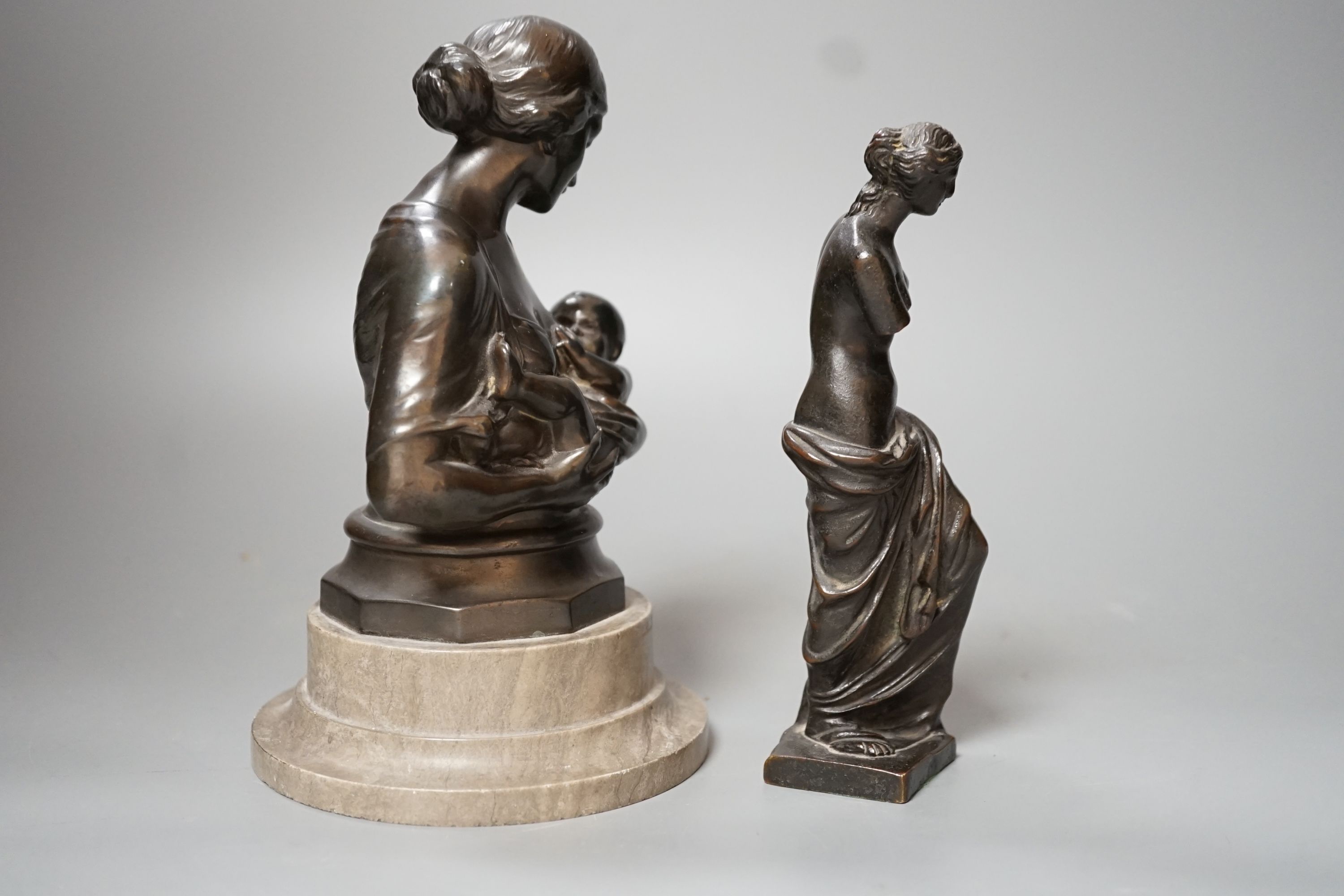 A bronze figure of the Venus de Milo, 16cm, together with another bronze bust of mother and child on plinth base, 19cm